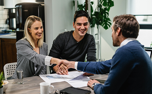 couple with woman shaking hands with contractor man